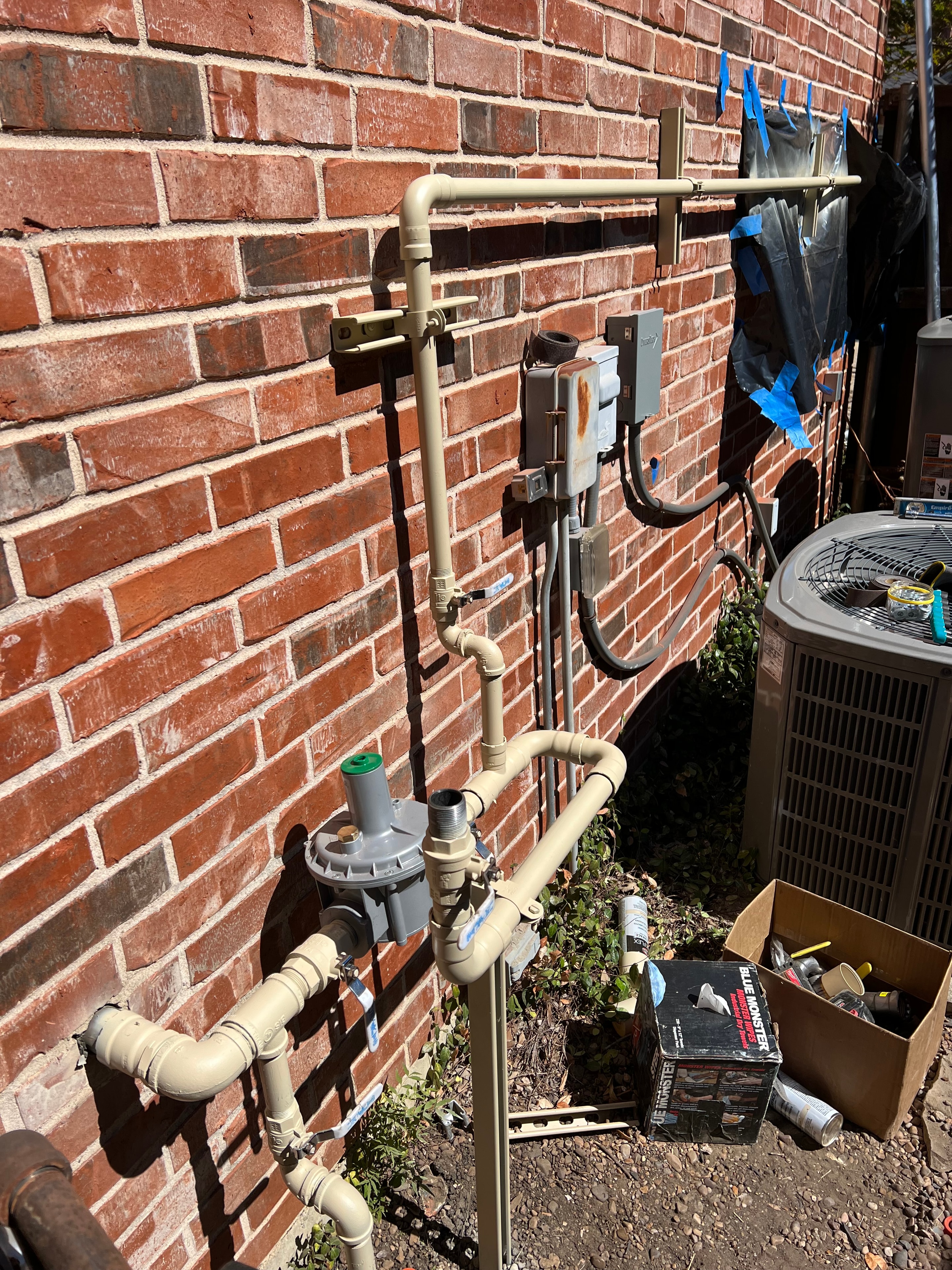 PVC plumbing pipes on brick wall